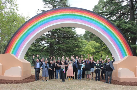 Big Rainbow with people standing under it