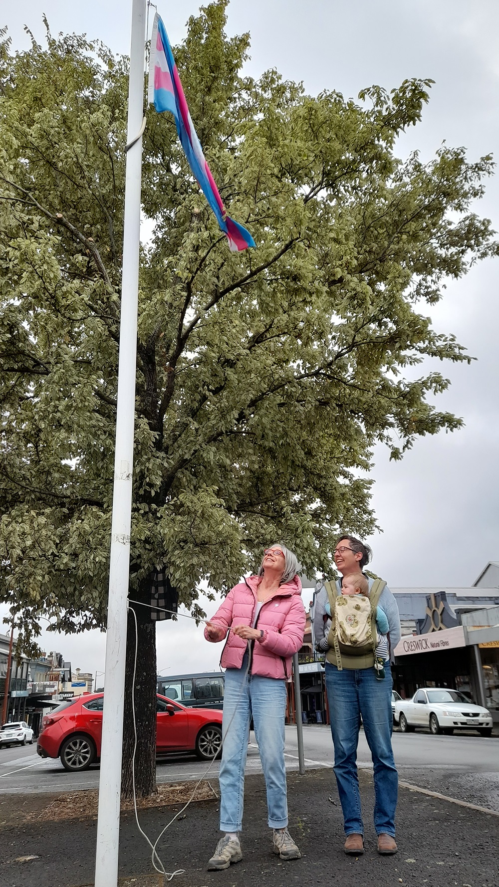 Grace Lee and Cr Tessa Halliday raise the trans flag
