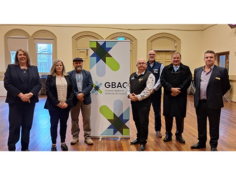 GBAC members standing in front of banner