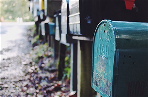 A row of mail boxes on a road