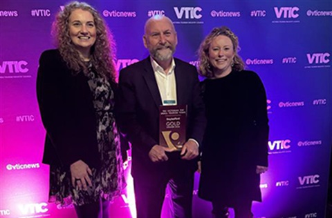 Dr Karina Lamb, Cr Brian Hood and Bridgette O'Brien holding award