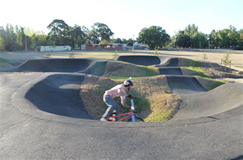 Person on a BMX riding around the pump track