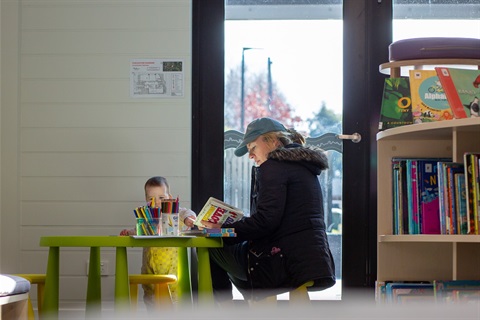 Parent reading in library